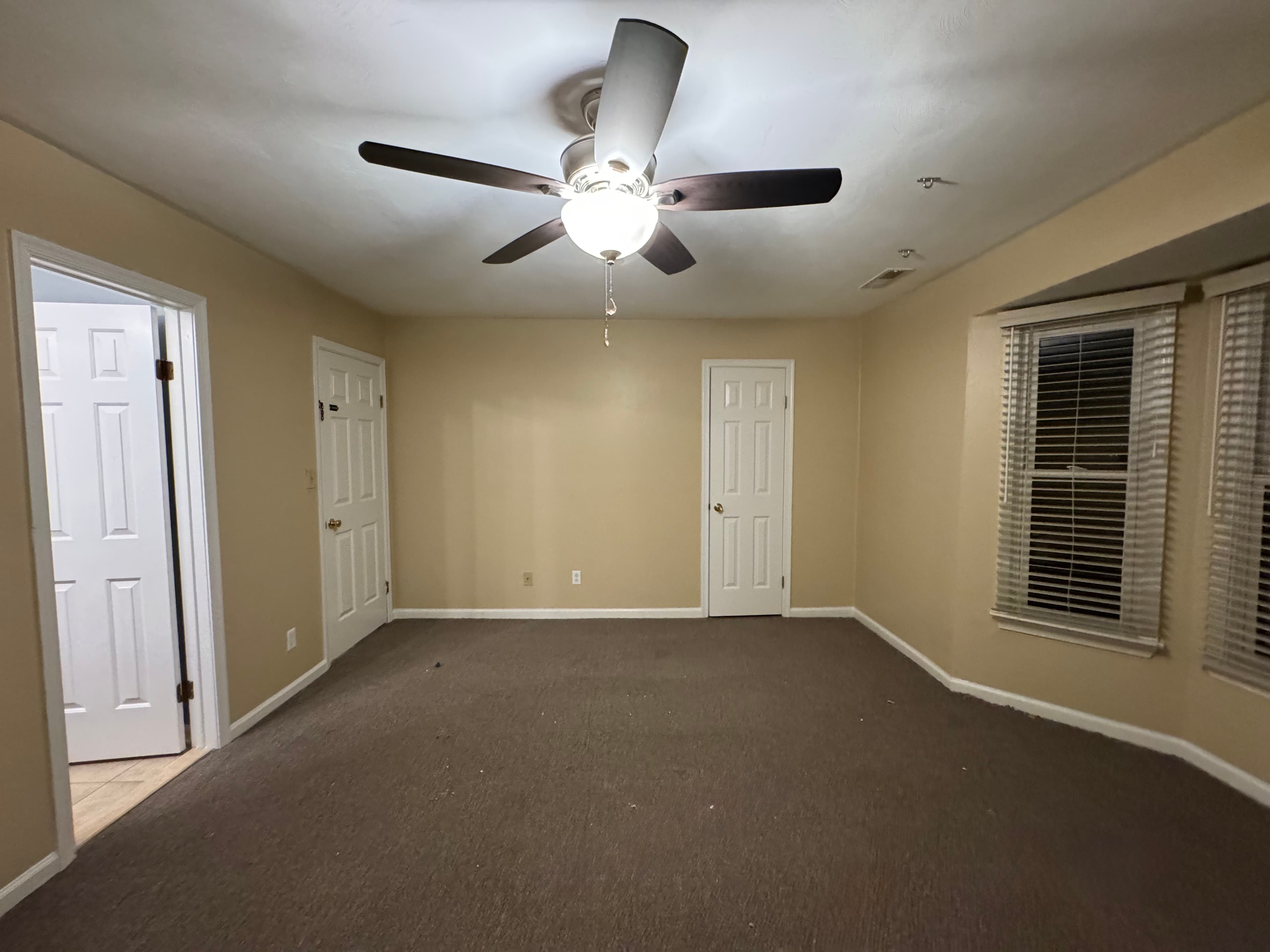 Bedroom with warm beige walls and professional paint finish